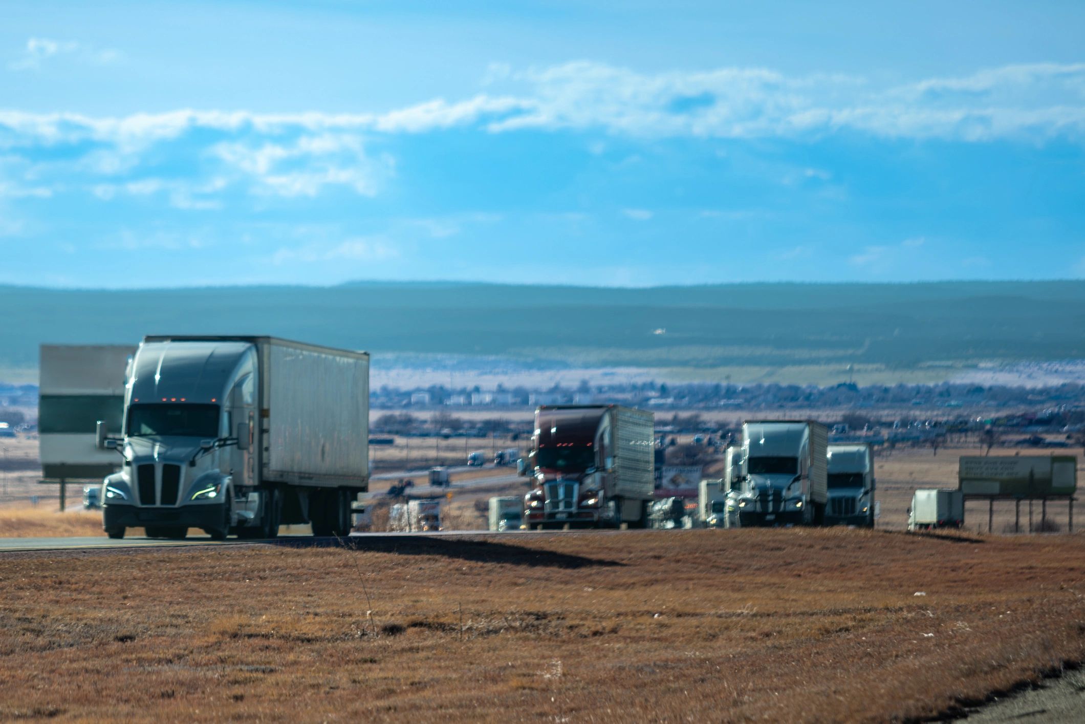 Commercial trucks lined up in a freight staging area